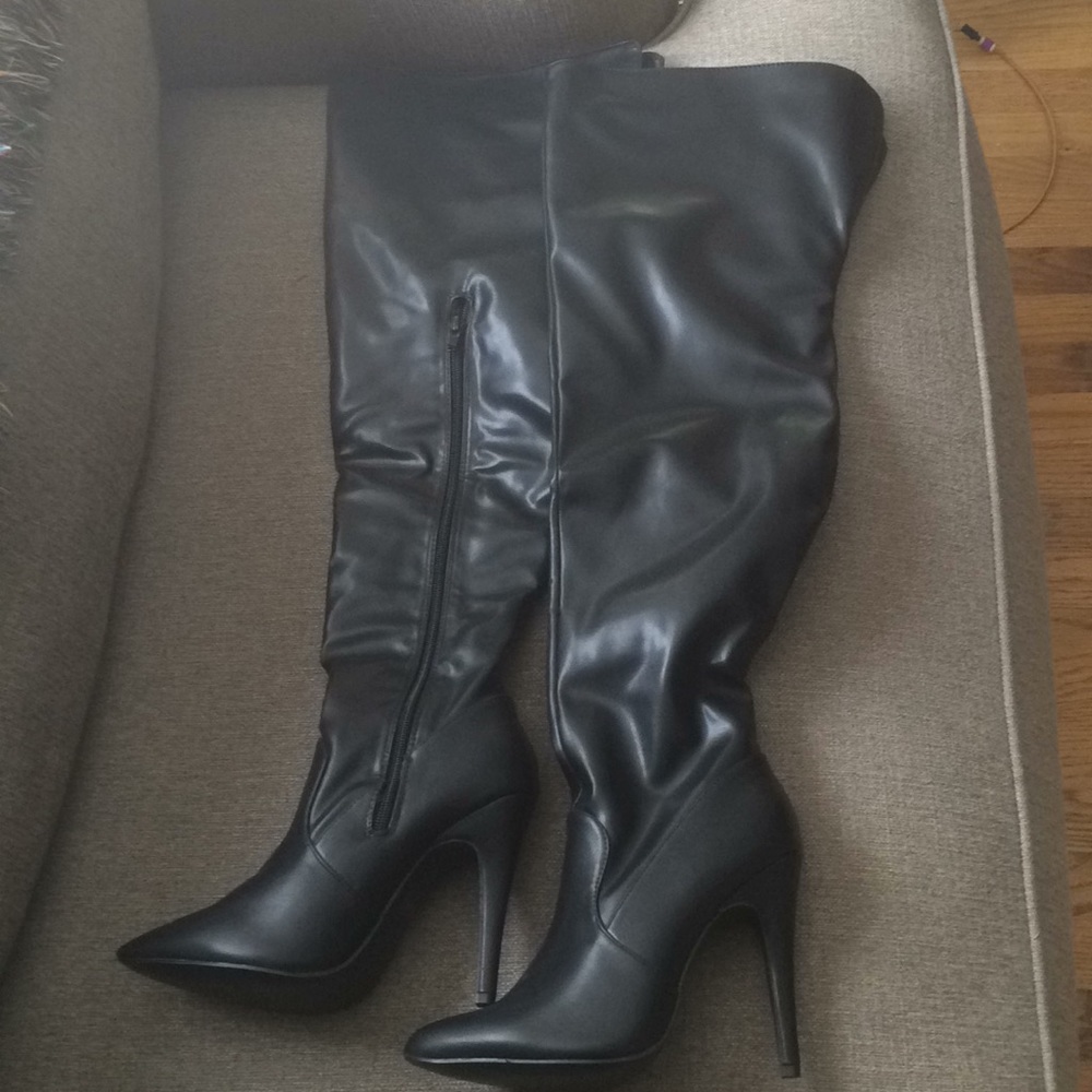 Black thigh high heeled boots